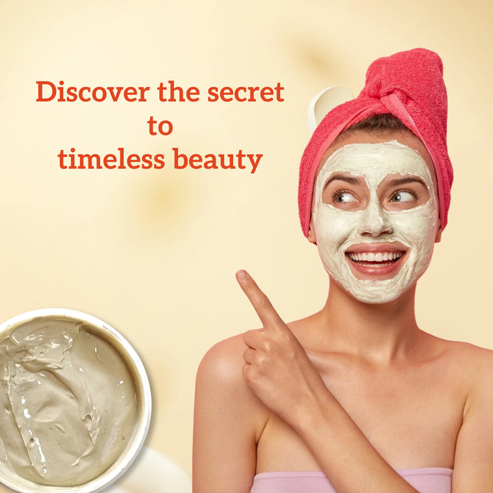 Woman with a facial mask pointing to a bowl of the same mask, with text 'Discover the secret to timeless beauty' on a beige background.