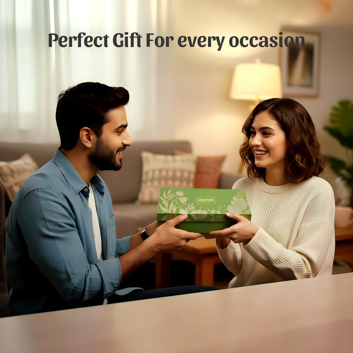 Man and woman exchanging a gift in a cozy living room.
